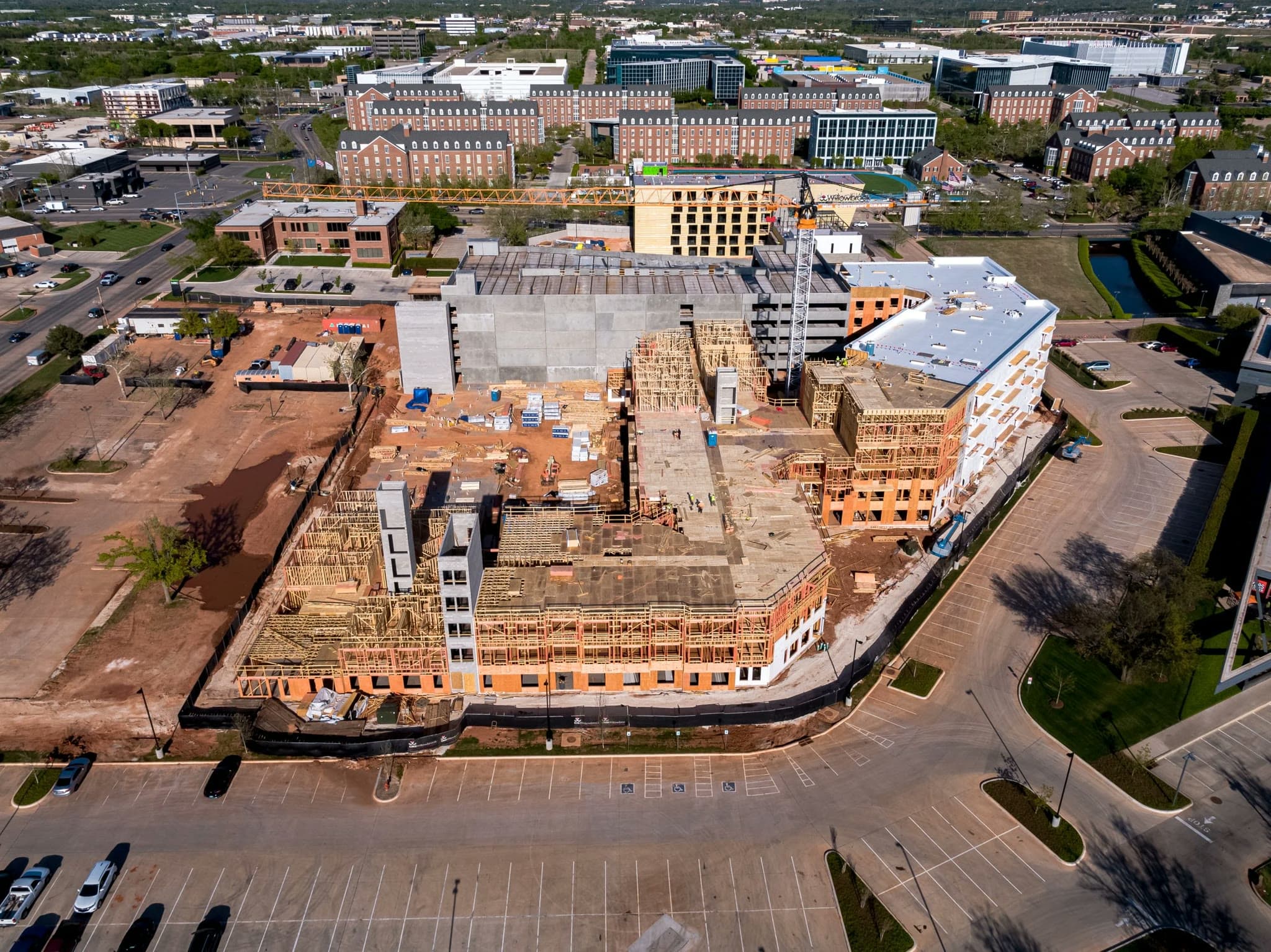 Weekly progress capture over a mid-rise framing stage.