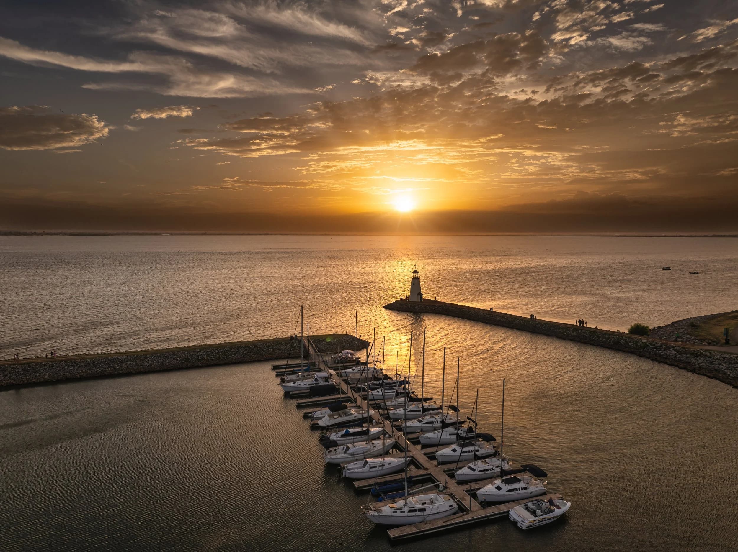 Lake Hefner at sunset: marina, sailboats, and the lighthouse.